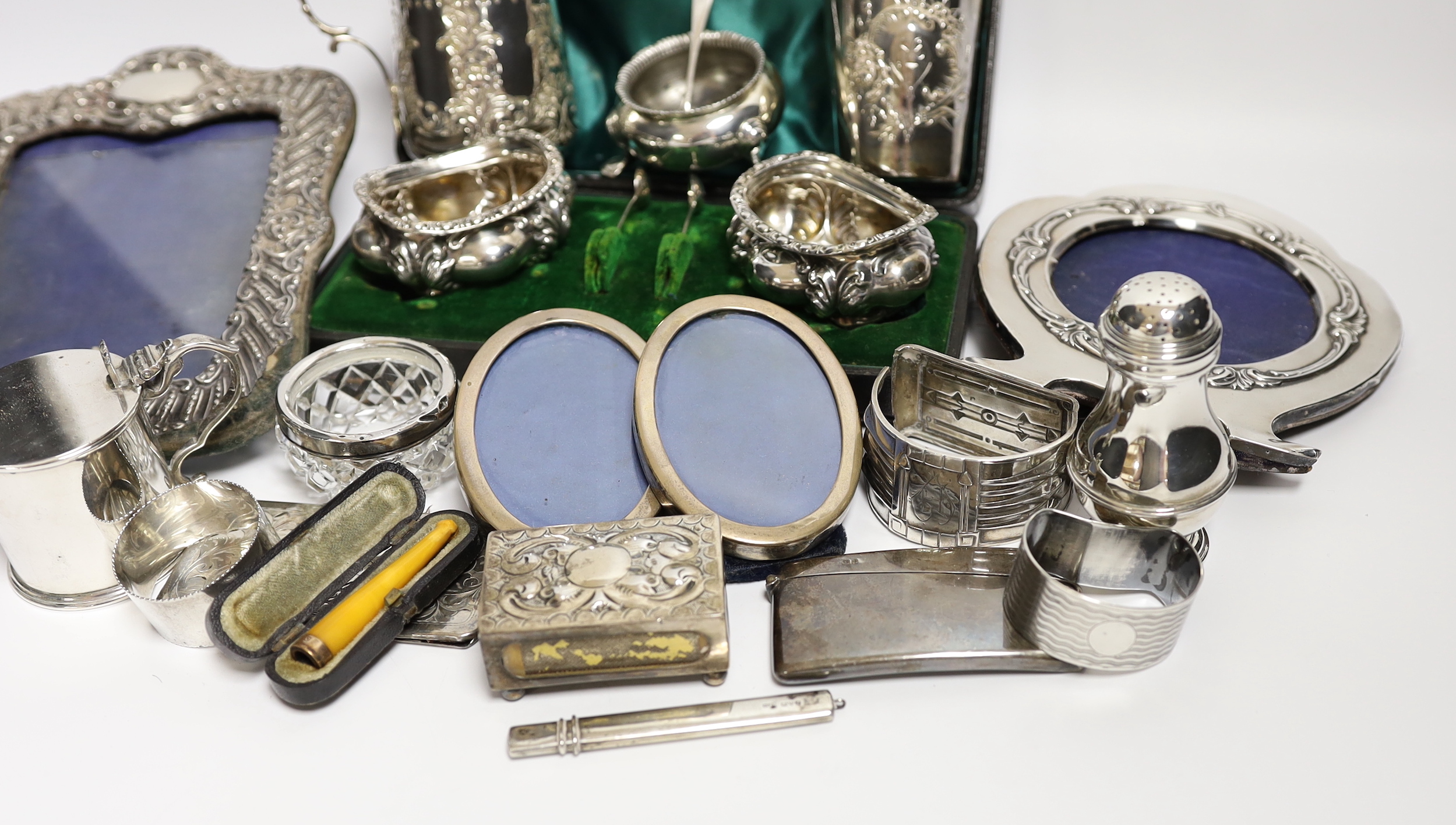 Sundry small silver and white metal items including Edwardian Christening mug, four mounted photograph frames, napkin rings, card cases, bun pepperette etc.